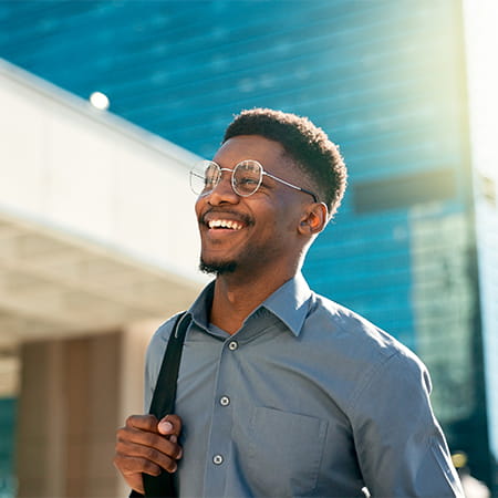 Business, happy and walking black man on city journey, commute trip and real estate agent smile on way to office building